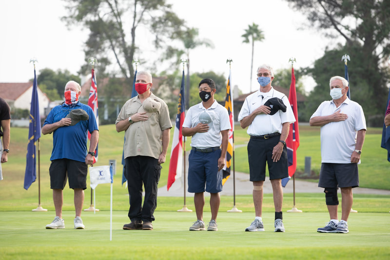 Charity Golf Tournament in Rancho Bernardo at the Oaks North Golf Club by the Los Rancheros Kiwanis Club.  Veterans standing at attention during the national anthem.
